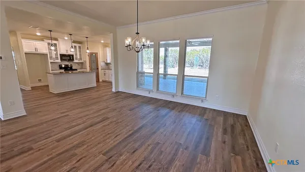 a view of a kitchen and wooden floor