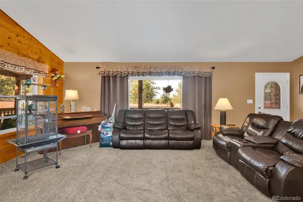 a living room with furniture a fireplace and a table