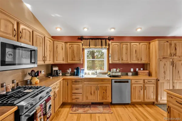 a kitchen with a sink stove top oven and cabinets