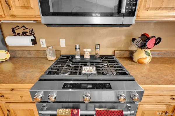 a stove top oven sitting inside of a kitchen