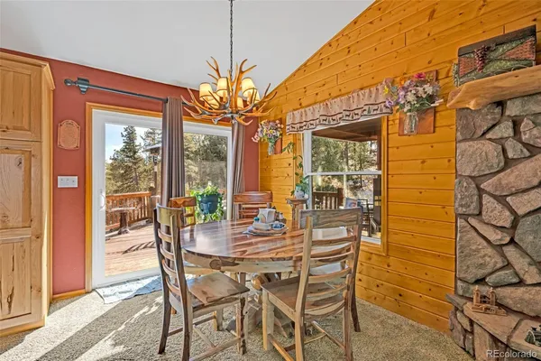 a view of a dining room with furniture wooden floor and chandelier