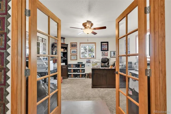 a view of a livingroom with furniture workspace and a window