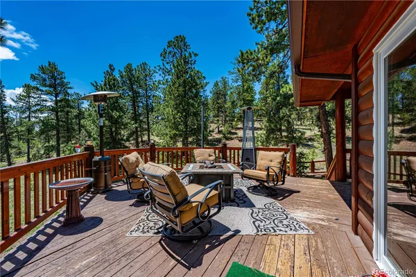 a view of balcony with wooden floor and outdoor seating
