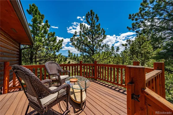 a view of balcony with wooden floor and outdoor seating