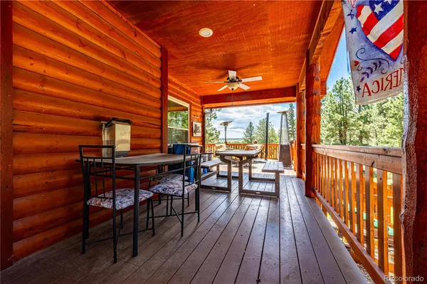 a view of a patio with a table and chairs and wooden floor