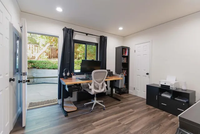 a work room with furniture and wooden floor