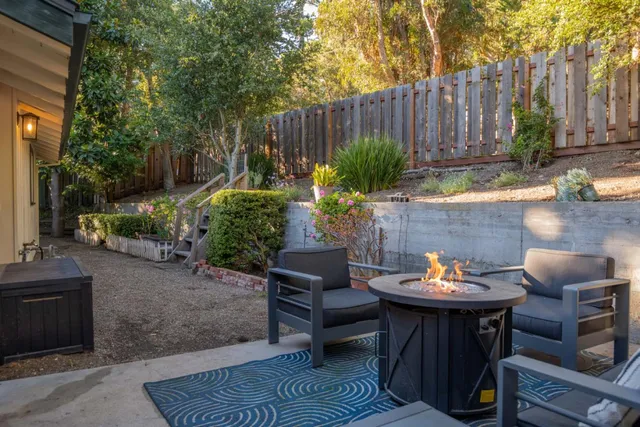 a view of a backyard with a patio and a fire pit