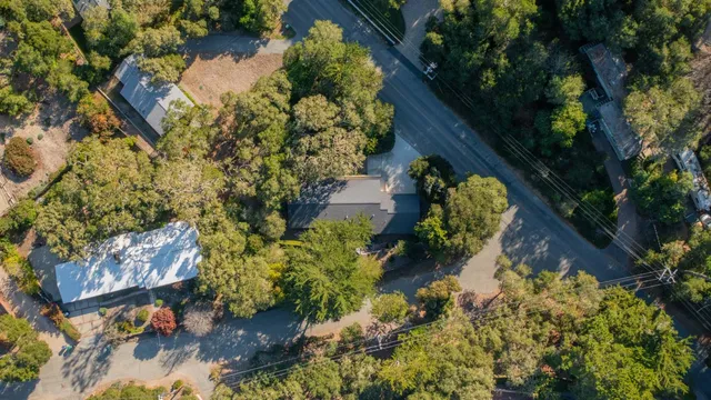 an aerial view of a house with a yard