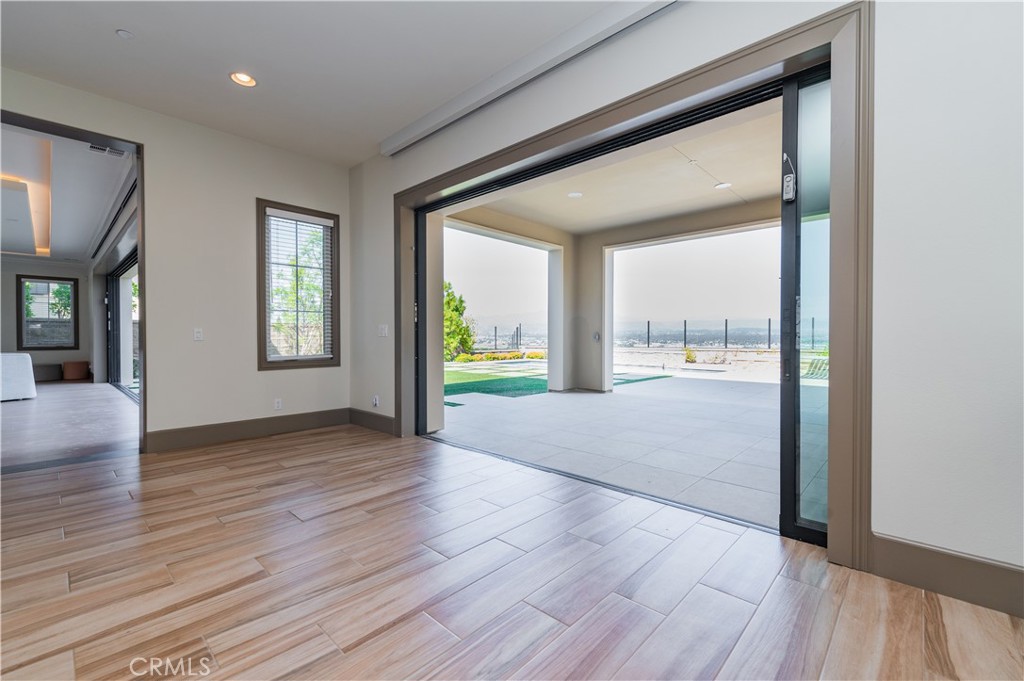 122 Scenic Crest Irvine, CA 92618 - Photo 12 of 68 a view of an empty room with wooden floor and a window