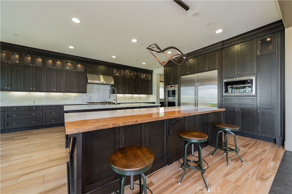 122 Scenic Crest Irvine, CA 92618 - Photo 15 of 68 a kitchen with stainless steel appliances kitchen island granite countertop a sink and a refrigerator