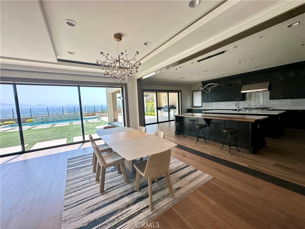 122 Scenic Crest Irvine, CA 92618 - Photo 19 of 68 a room with wooden floor table and chairs