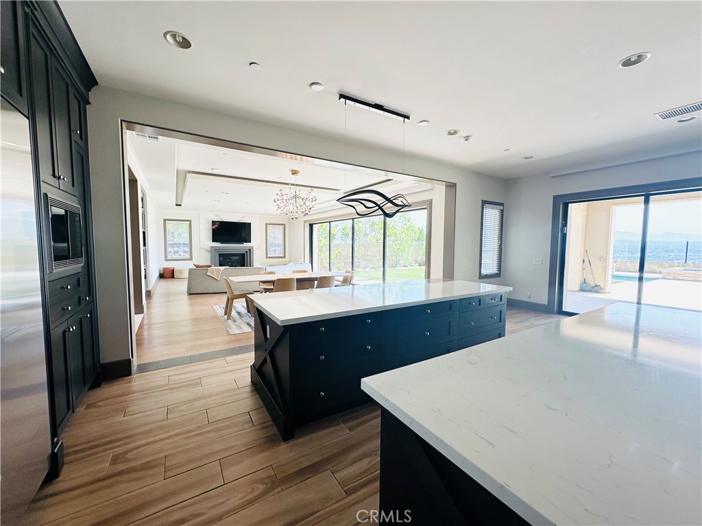 122 Scenic Crest Irvine, CA 92618 - Photo 24 of 68 a kitchen with stainless steel appliances granite countertop a sink dishwasher and a dining table with wooden floor