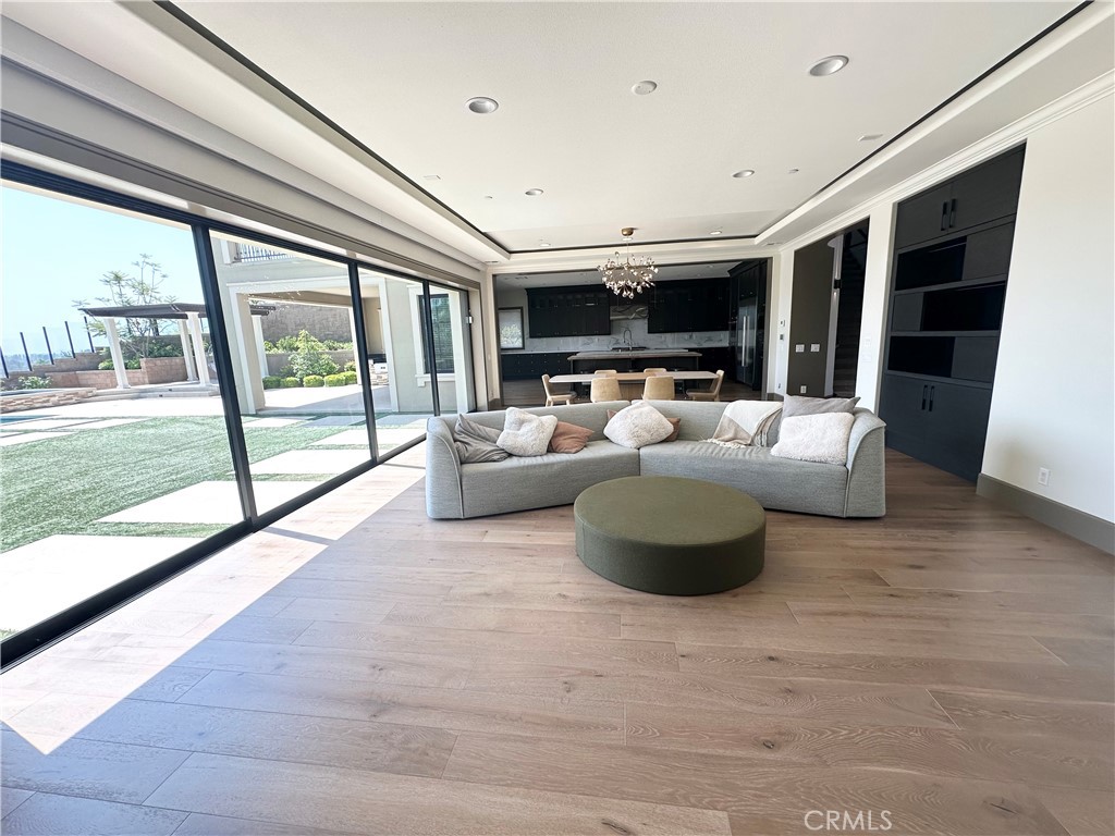 122 Scenic Crest Irvine, CA 92618 - Photo 25 of 68 a living room with furniture a flat screen tv and a large window
