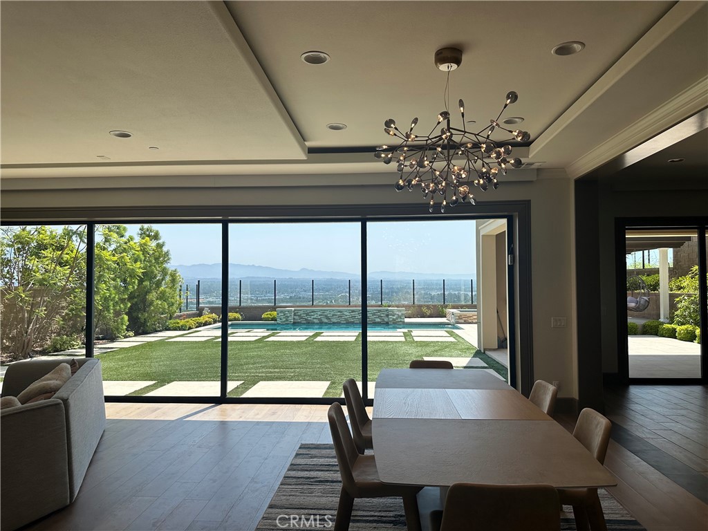 122 Scenic Crest Irvine, CA 92618 - Photo 26 of 68 a view of a dining room with furniture a chandelier and large windows