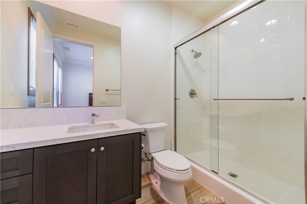 122 Scenic Crest Irvine, CA 92618 - Photo 30 of 68 a bathroom with a double vanity sink toilet mirror and shower