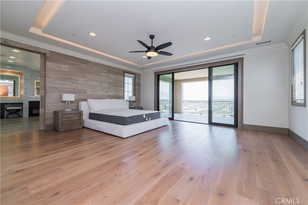 122 Scenic Crest Irvine, CA 92618 - Photo 32 of 68 a spacious bedroom with a balcony a bed and a large window