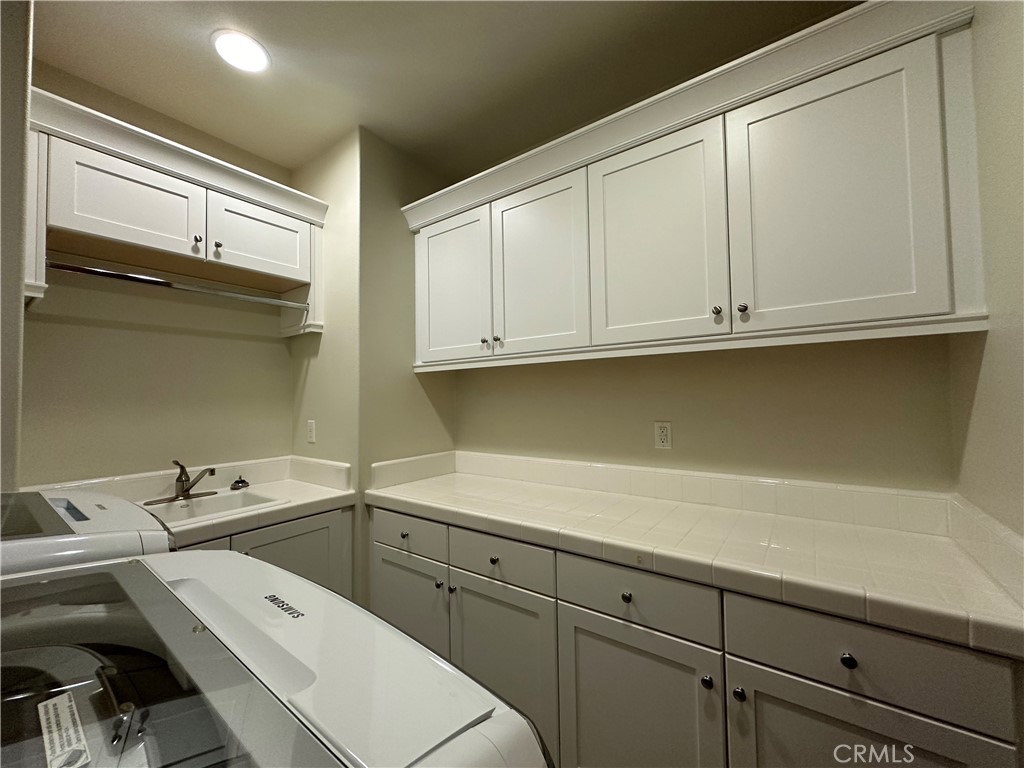 122 Scenic Crest Irvine, CA 92618 - Photo 40 of 68 a view of a kitchen with white cabinets
