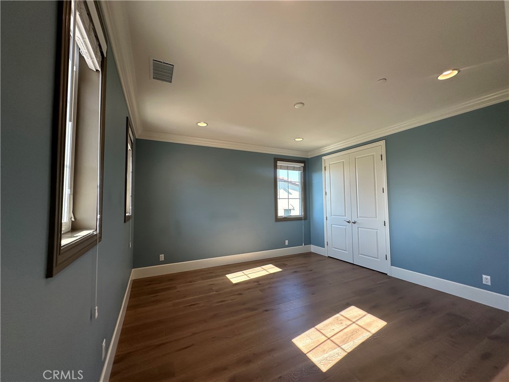 122 Scenic Crest Irvine, CA 92618 - Photo 43 of 68 a view of empty room with window and wooden floor