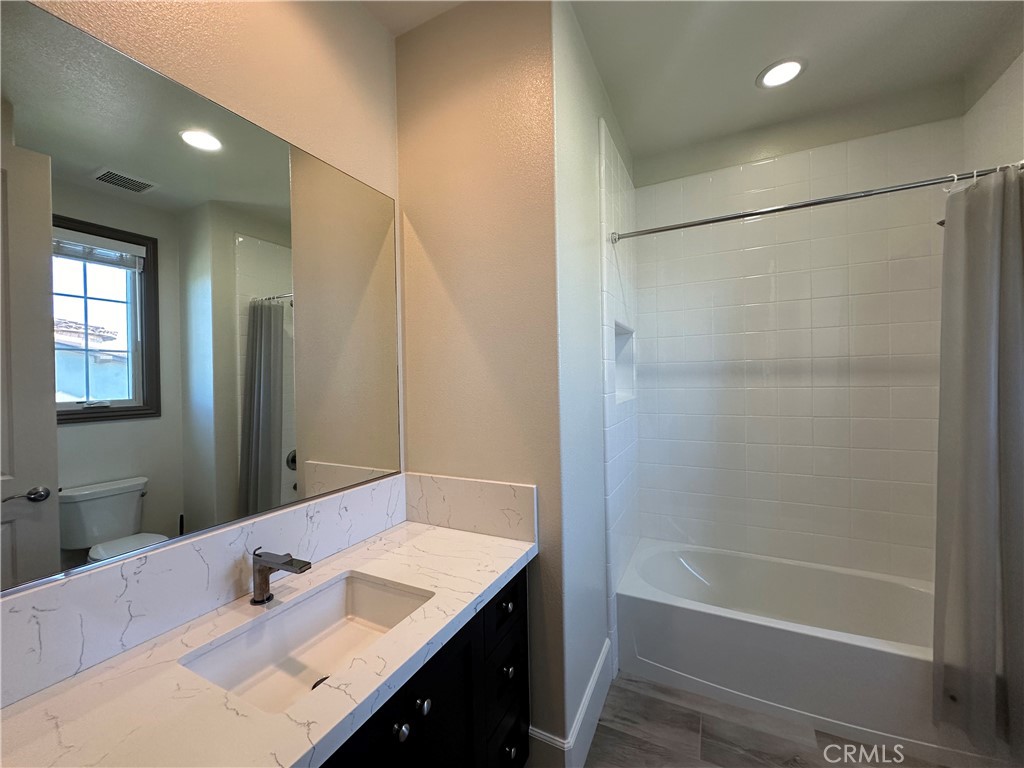122 Scenic Crest Irvine, CA 92618 - Photo 45 of 68 a bathroom with a tub shower sink vanity and a mirror
