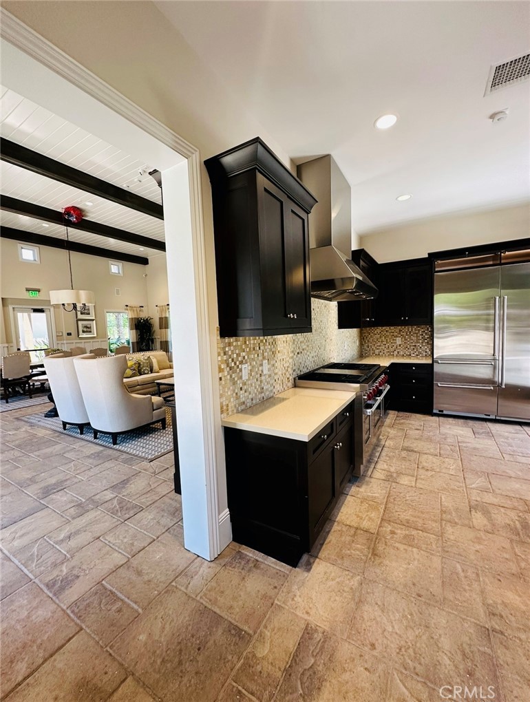 122 Scenic Crest Irvine, CA 92618 - Photo 66 of 68 a large kitchen with kitchen island granite countertop a sink and a stove top oven