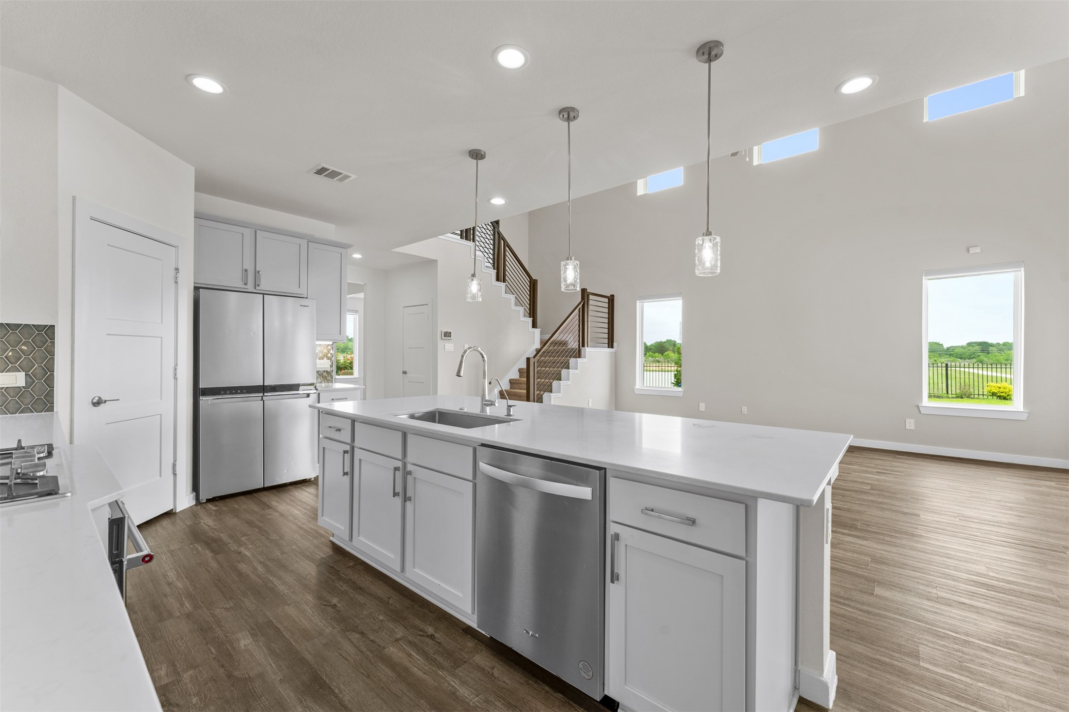 22503 Modica Rift Lane Katy, TX 77449 - Photo 13 of 47 a kitchen with white cabinets and stainless steel appliances
