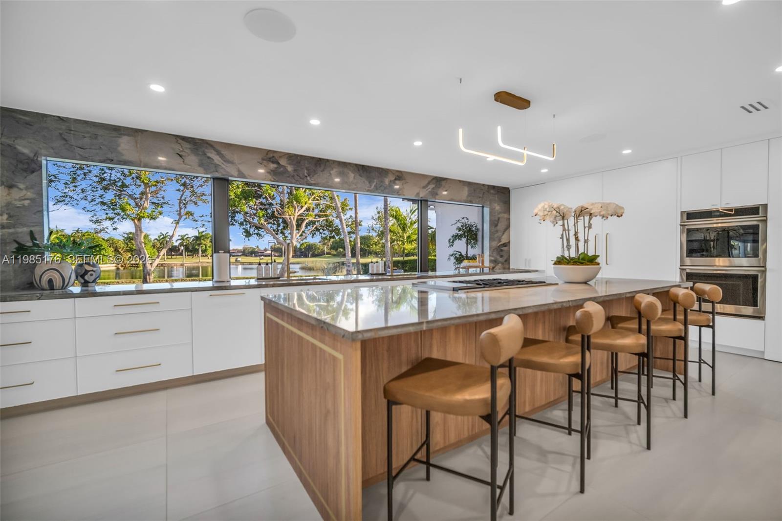 4430 Casper Court Hollywood, FL 33021 - Photo 14 of 64 a kitchen with stainless steel appliances kitchen island granite countertop a table and chairs in it