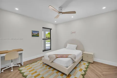 a bedroom with a bed couch and a window