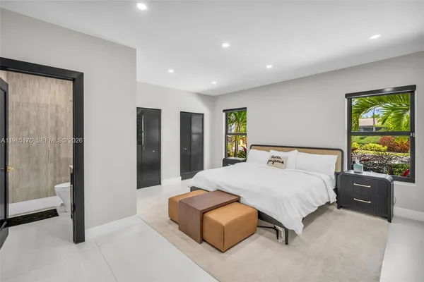 a bedroom with a bed and a painting on the wall