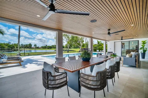 a view of swimming pool with outdoor seating and yard in back