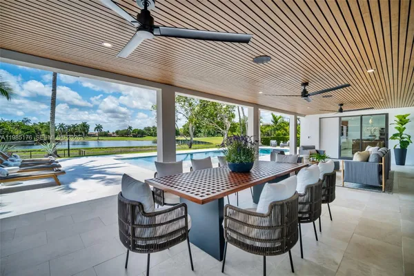 a view of swimming pool with outdoor seating and yard in back