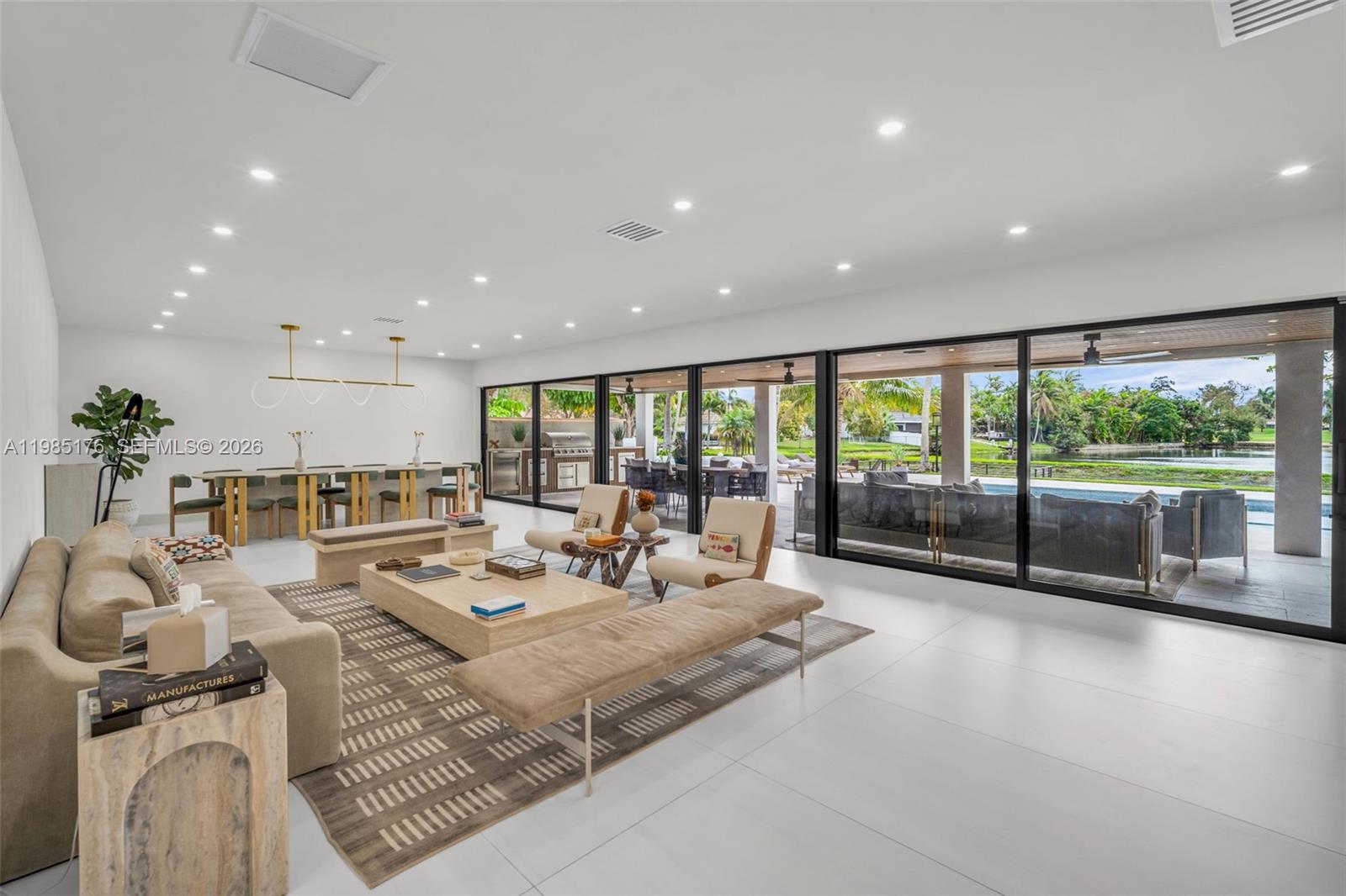 4430 Casper Court Hollywood, FL 33021 - Photo 4 of 64 a living room with furniture large windows and a table