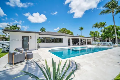 a view of swimming pool with a bench in front of it