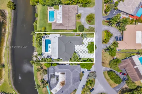 a view of pool with lawn chairs and palm tree