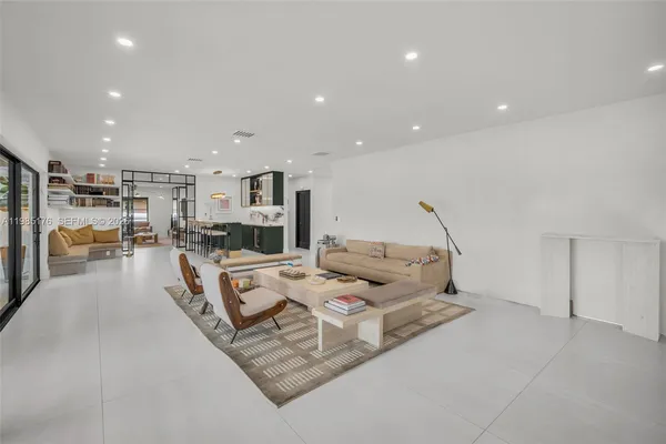 a living room with furniture a pool and a sink