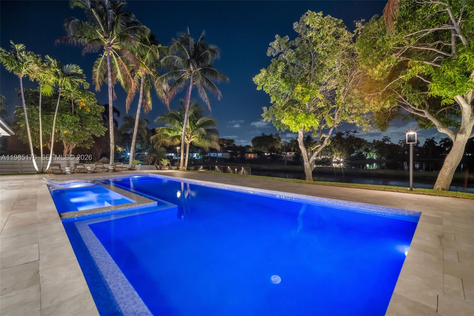 4430 Casper Court Hollywood, FL 33021 - Photo 63 of 64 a view of pool with lawn chairs and palm tree
