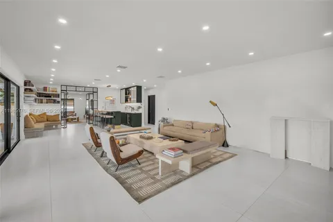 a living room with furniture and a large mirror