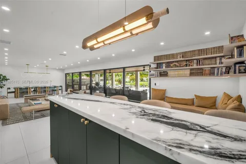 a large kitchen with stainless steel appliances granite countertop a lot of counter space and a sink
