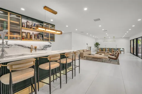 a large kitchen with stainless steel appliances granite countertop a lot of counter space and a sink