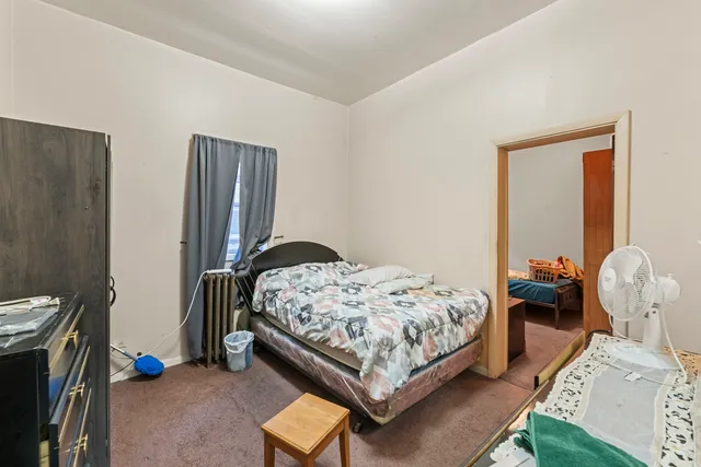 a bedroom with bed and a window