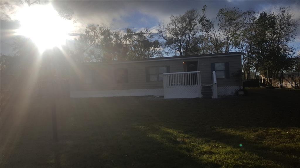 a view of house with backyard