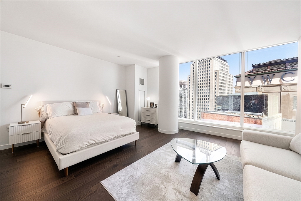 40 Trinity Place, Unit 1518 Boston, MA 02116 - Photo 1 of 25 a bedroom with a bed and a couch
