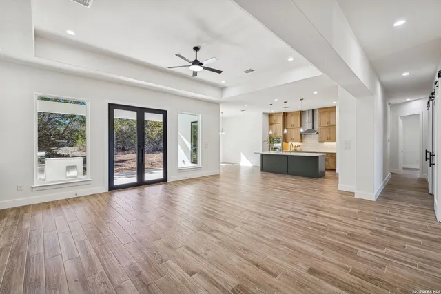 a kitchen with kitchen island a stove a refrigerator a sink dishwasher with a dining table and chairs