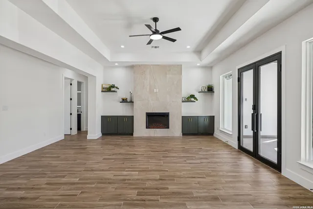 a kitchen with stainless steel appliances granite countertop a sink a counter space and wooden floor