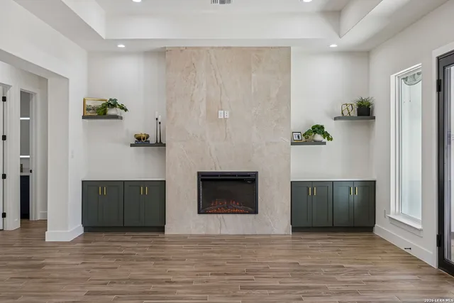 a view of a kitchen with kitchen island a sink wooden floor and a living room view