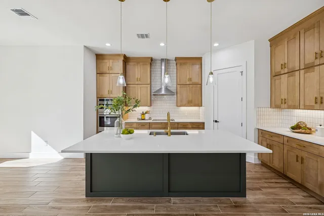 a spacious bathroom with a double vanity sink a mirror and a shower