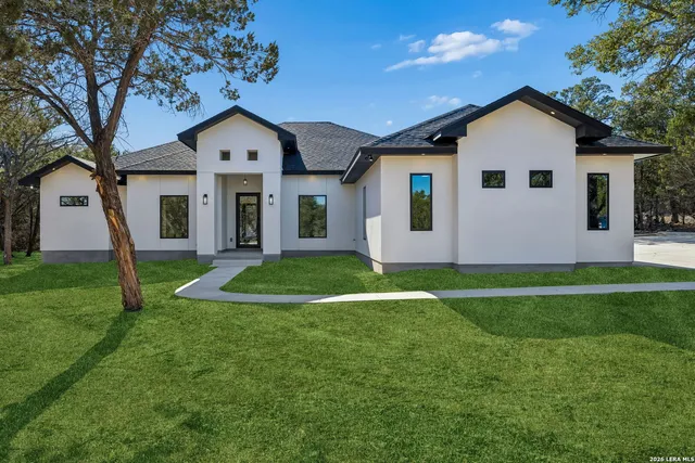 a front view of house with yard and green space