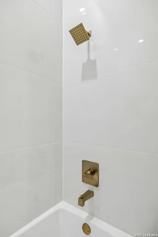 an aerial view of a houses with a yard and lake view