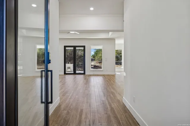 a view of a livingroom with a fireplace a ceiling fan and hardwood floor