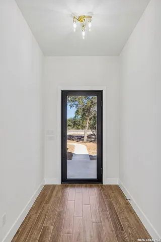 a kitchen with kitchen island granite countertop a sink cabinets and stainless steel appliances