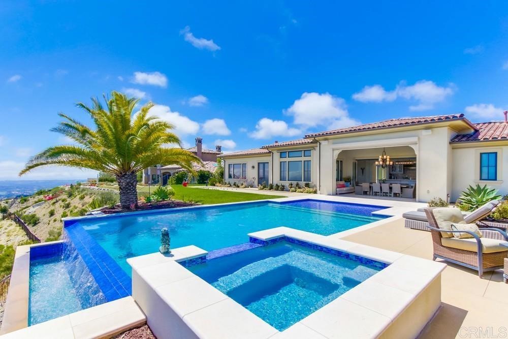 8785 Via Rancho Cielo Rancho Santa Fe, CA 92067 - Photo 1 of 1 a view of a house with swimming pool and sitting area